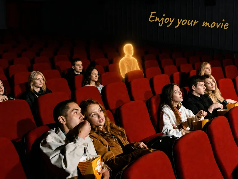 Cinema seats with a gold note saying enjoy your movie